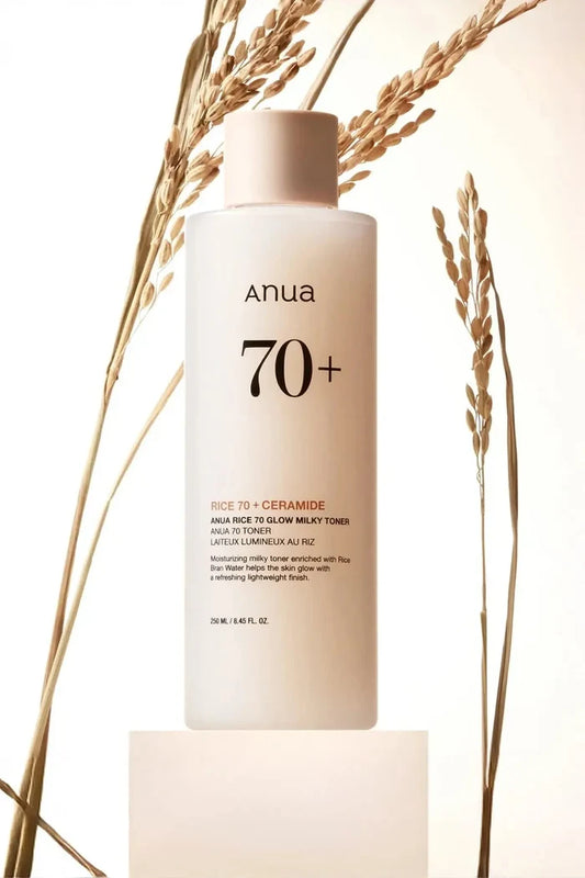 Anua Rice 70 Glow Milky Toner bottle displayed with rice stalks, a nourishing Rice Water Toner for a radiant finish.